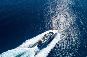Aerial shot of a yacht sailing on the sea at daytime An aerial shot of a yacht sailing on the sea at daytime